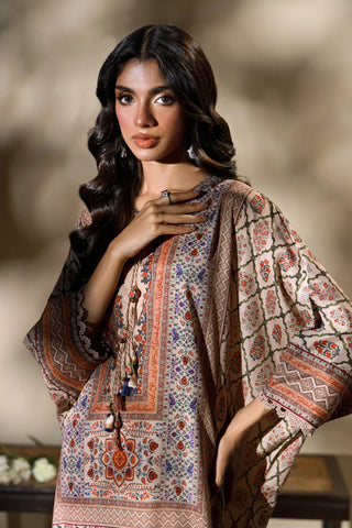 Manto's Alira long length Kaftaan in shades of sand, paired with straight pants. 