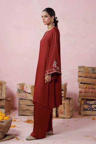 Red 2 piece herringbone set with a short shirt and shalwar, featuring urdu words.