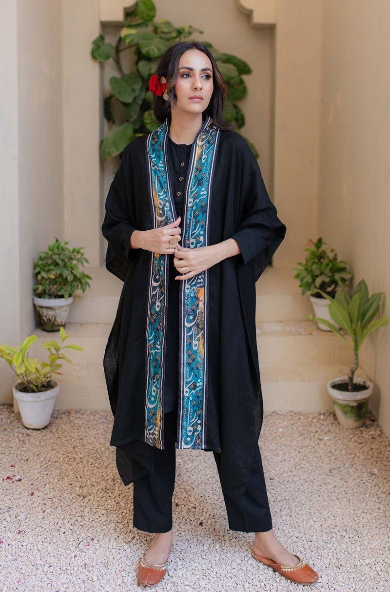 Shopmanto, wear manto, manto clothing brand, unisex cape shawl, cape shawl, men cape shawl, women cape shawl, capes, shawl, winter wear, eastern, western, urdu calligraphy on the cape shawl, cape in black, shahkaar cape, men outerwear, women outerwear, shahkaar cape black and teal, manto capes, manto shawl