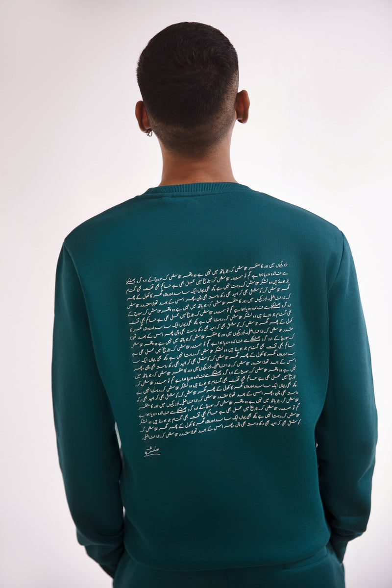 Shopmanto, wear manto, pakistan, women, men, ladies, clothing, urdu, calligraphy, hoodies, sweatshirt, jogger pants, winter wear, karachi, western clothing, manto store, urdu calligraphy clothing, unisex hoodies, unisex winter wear, sweatshirts in pakistan, sweatshirts for men, sweatshirts for women, unisex sweatshirts, comfort, soft, track suit, deep teal Talaash Sweatshirt, text print at the back of sweatshirt, text print on sleeves, printed sweatshirt, comfort revolution